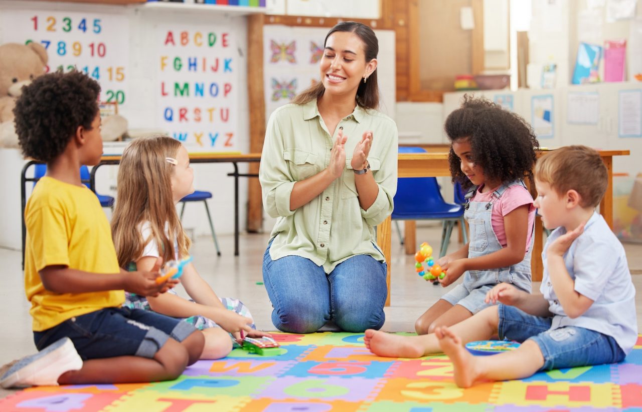 Shot of a teacher singing with her preschool children.jpg